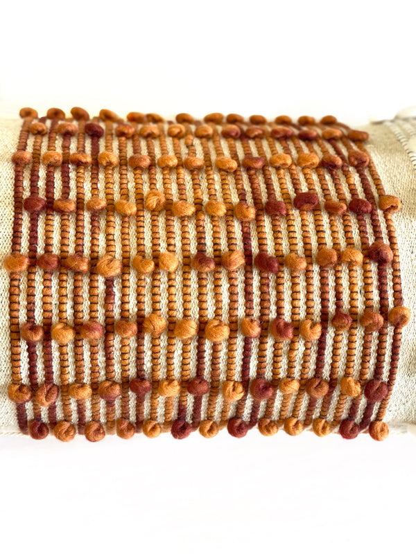 casa boho decorative lumbar pillow cover long cushion burnt orange rust colored coral salmon beige tan taupe white cotton wool tassels tassel fringe fringed texture textured mid century modern bohemian eclectic interior stylist designer decorator decorating home decor living room bedroom sofa couch chair crib bed bench outdoor indoor loops aqua blue turquoise
